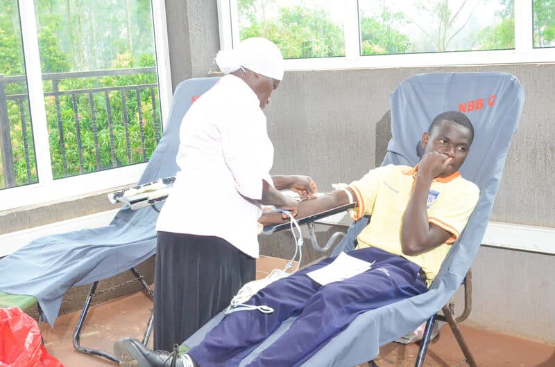 Health worker drawing blood from a donor at the Rotary blood donation drive