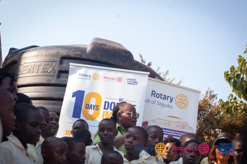 Pupils gathered at a water tank donated under 10 Days of Double Impact