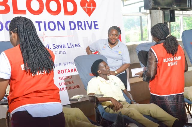 Blood bank staff attending to a donor at the Rotary blood donation drive